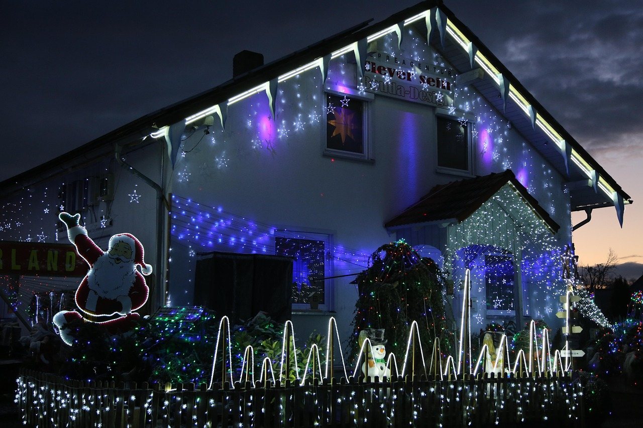House outlined in lights with a lit yard display