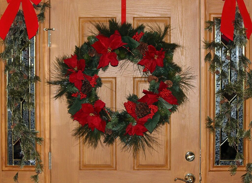 Christmas wreaths hung on a front entry door
