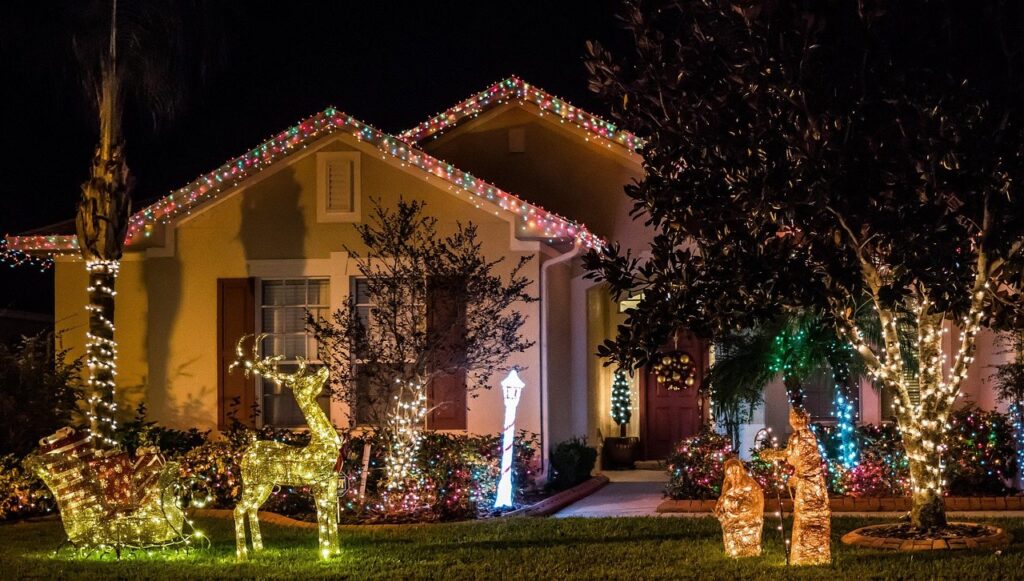 House outlined in warm Christmas lights
