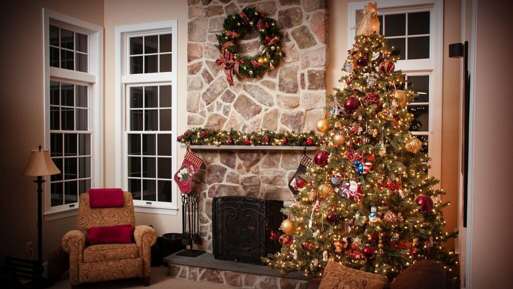 Front porch decorated with a wreath and a lit tree