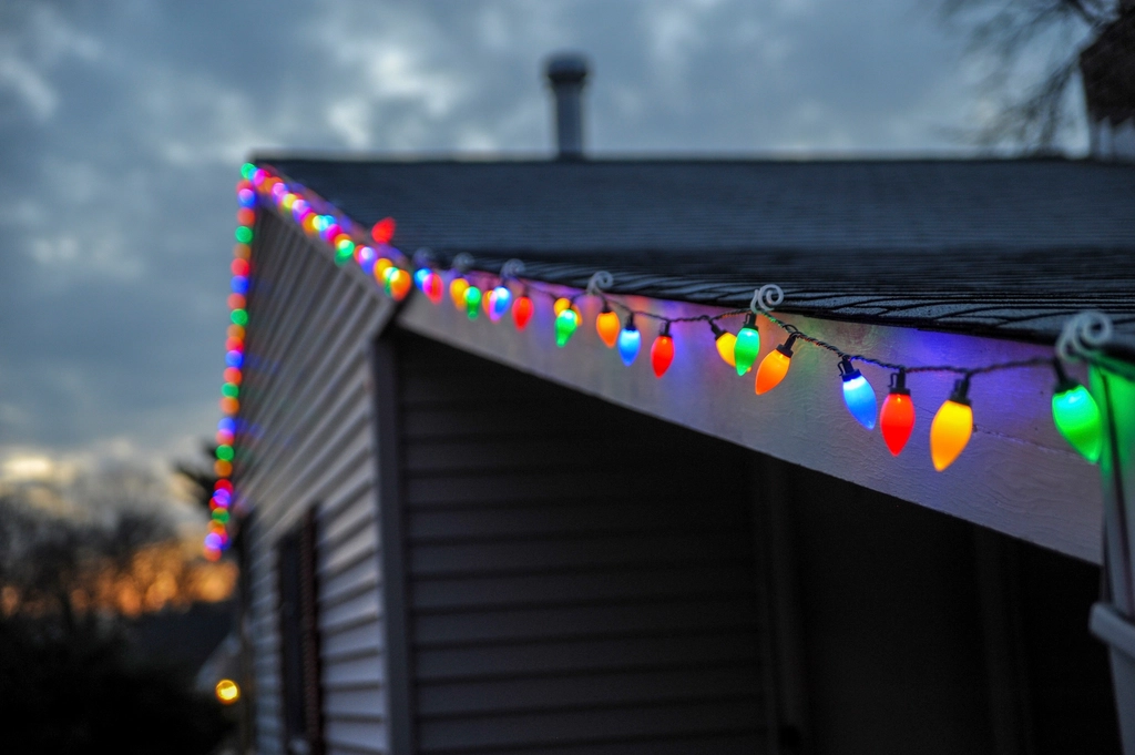 String Christmas lights running along a house roofline
