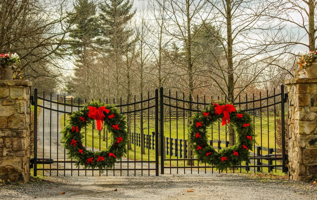 Christmas wreaths hung on an entry gate