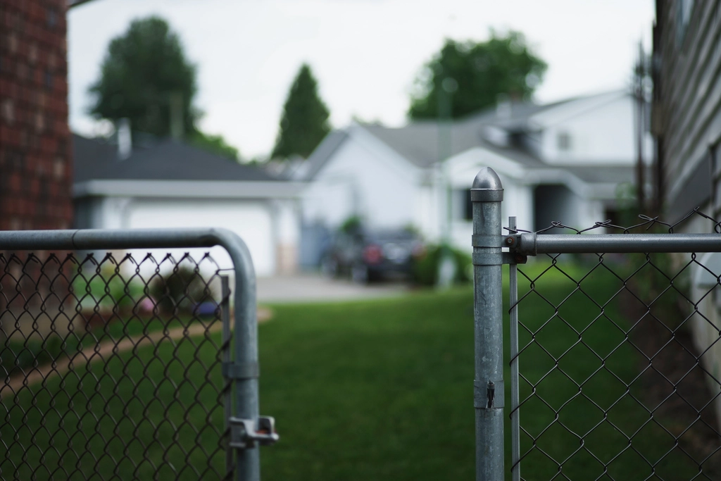 Chain link gate in front of a suburban home