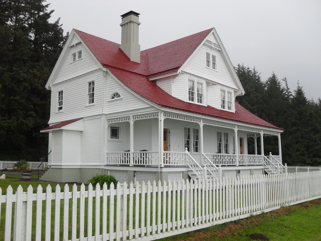 Two-story home with a white picket fence