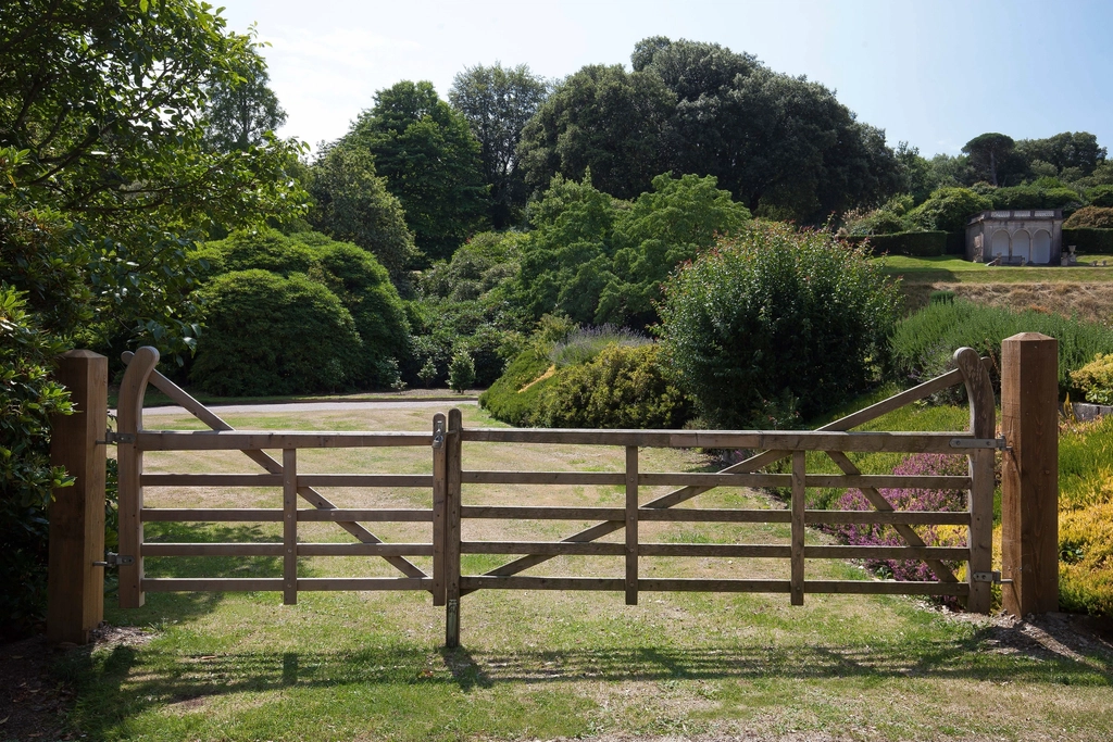 Wooden gate across a driveway entrance