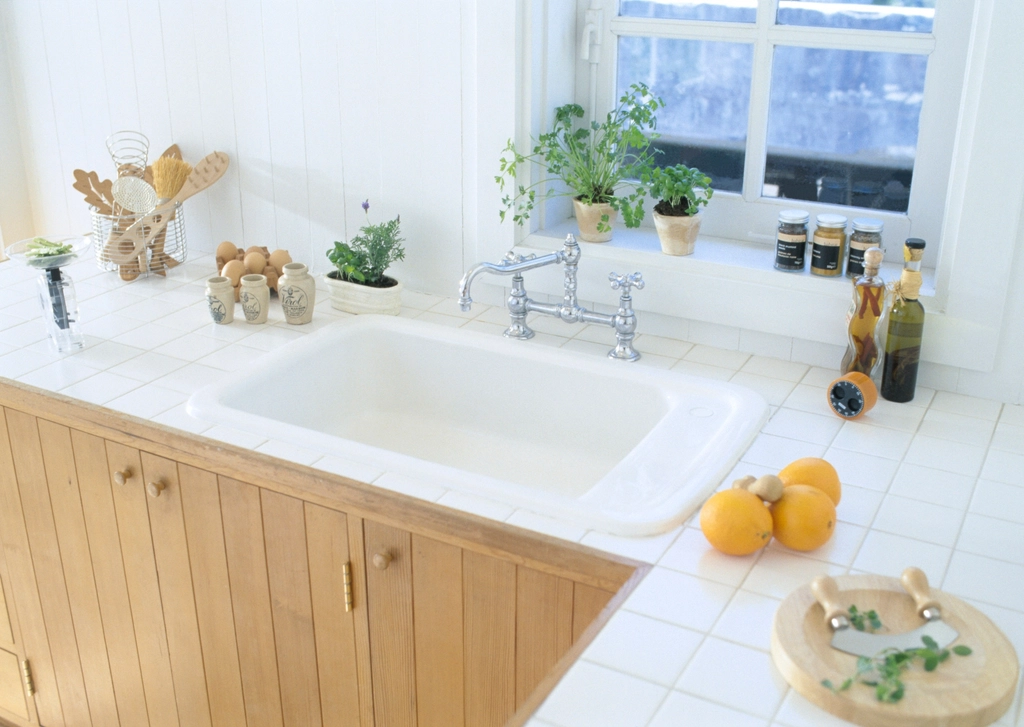 Farmhouse sink set in a white tile countertop