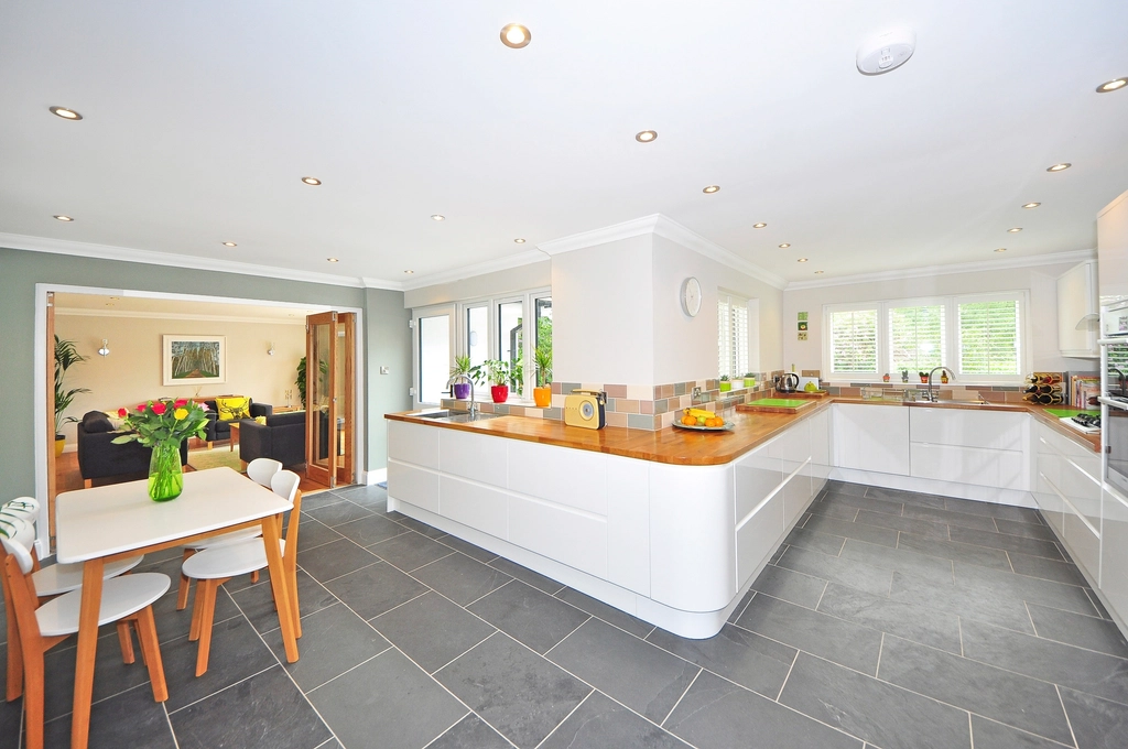 Open-plan kitchen with a tile floor and dining area