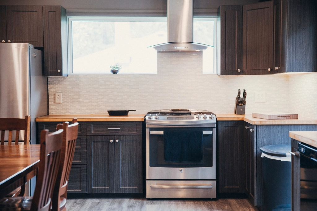 Kitchen with shaker cabinets and a stainless range