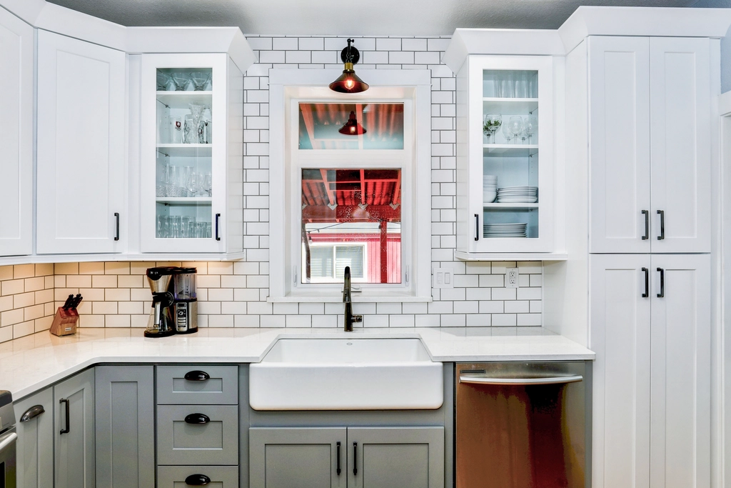 White kitchen with subway tile and a farmhouse sink