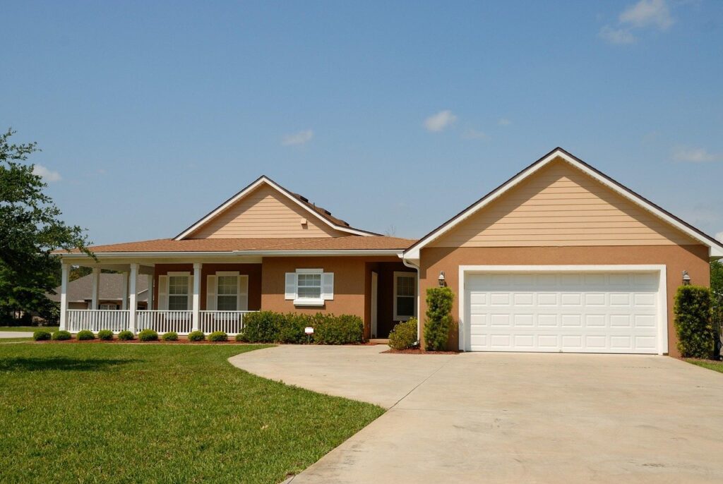 Single-story home with freshly painted siding and garage