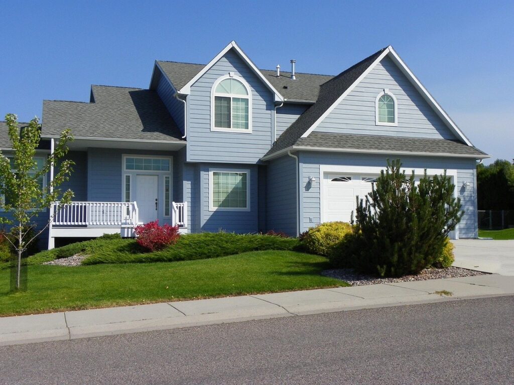 Blue home with white trim after exterior painting