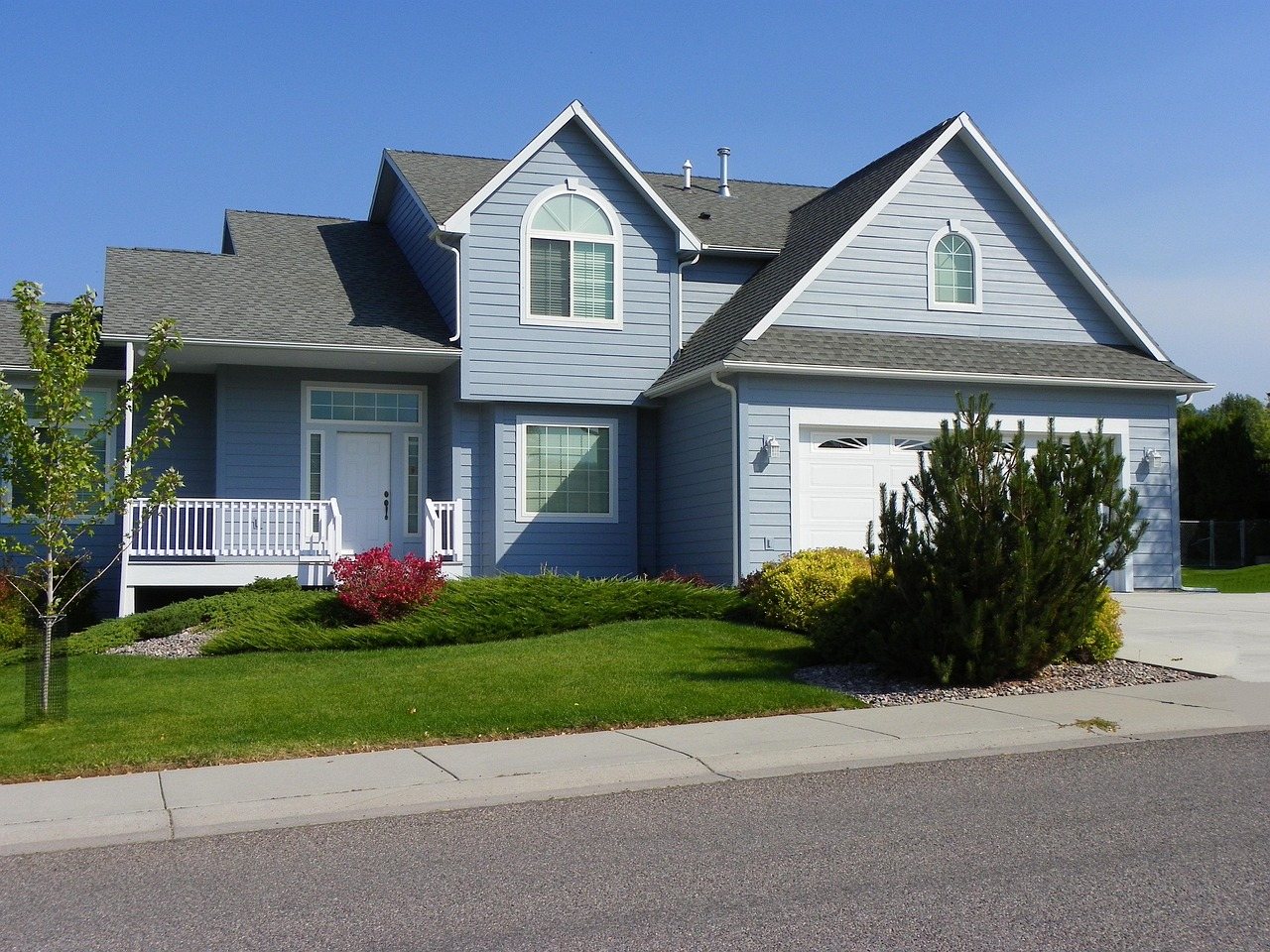 Blue home with white trim after exterior painting