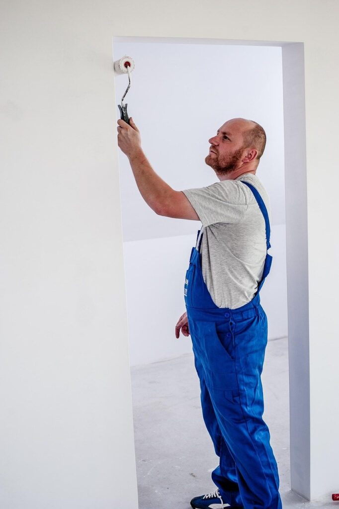 Painter rolling a fresh coat onto an interior wall