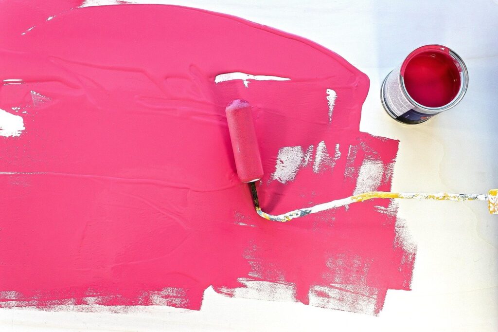 Roller laying a fresh coat of color across a wall