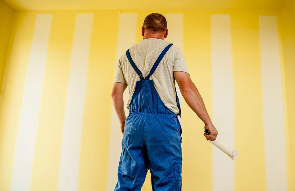 Painter rolling a fresh coat onto an interior wall